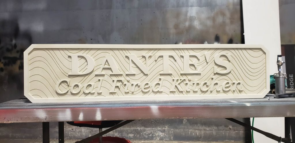 Raised lettering and textured HDU background before the contrasting finish.